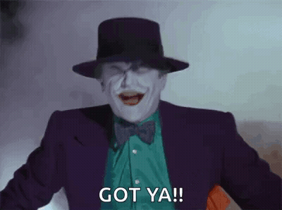 The Joker Is Wearing A Top Hat And Bow Tie And Is Laughing And Saying `` Got Ya '' . GIF