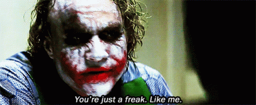 The Joker Says " You 'Re Just A Freak Like Me " In A Dark Room GIF