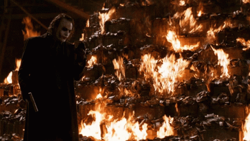 The Joker Stands In Front Of A Wall Of Fire GIF
