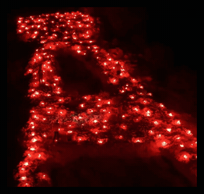 The Letter A Is Lit Up In Red Candles GIF