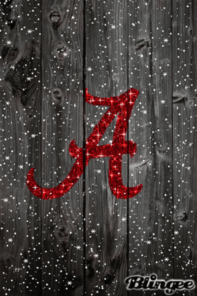The Letter A Is Written In Red Glitter On A Wooden Surface GIF