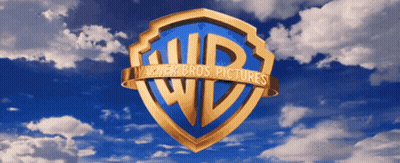 The Logo For Warner Bros Pictures Against A Blue Sky With Clouds GIF