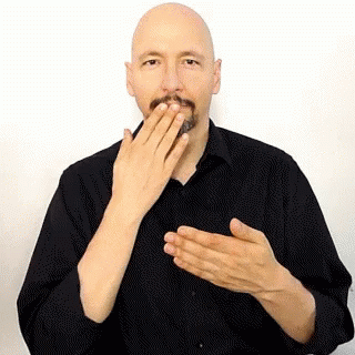 The Man Is Wearing A Black Shirt And Covering His Mouth With His Hands . GIF