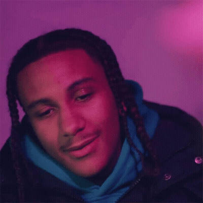 The Man Is Wearing A Blue Hoodie And A Black Jacket And Is Smiling . GIF