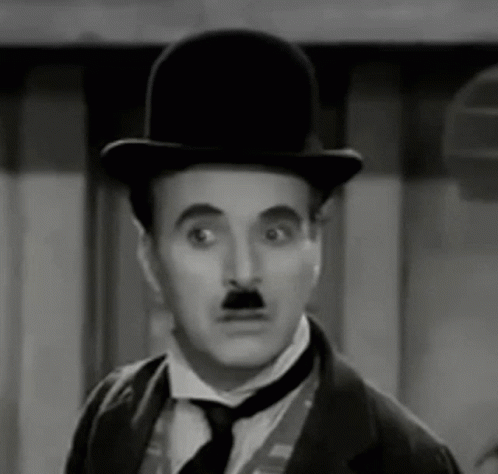 The Man Is Wearing A Top Hat And Tie And Has A Mustache . GIF