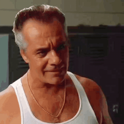 The Man Is Wearing A White Tank Top And A Gold Chain Around His Neck . GIF