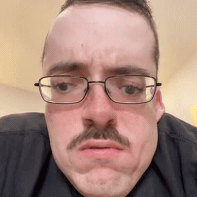 The Man Is Wearing Glasses And A Mustache And Making A Funny Face . GIF