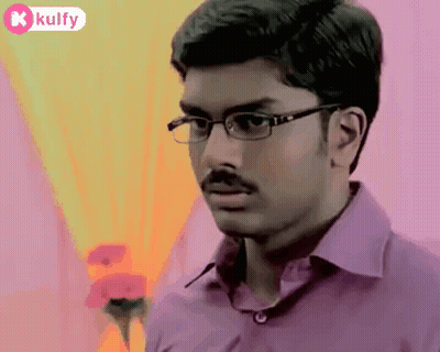 The Man Is Wearing Glasses And A Purple Shirt . GIF