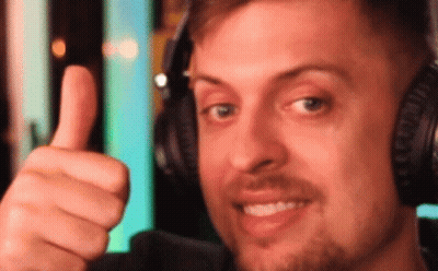 The Man Is Wearing Headphones And Giving A Thumbs Up GIF