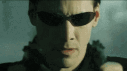 The Matrix Neo Firing Guns GIF