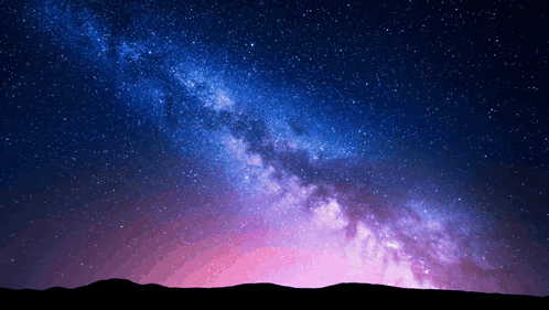 The Milky Way Galaxy Is Visible In The Night Sky Above A Mountain Range GIF