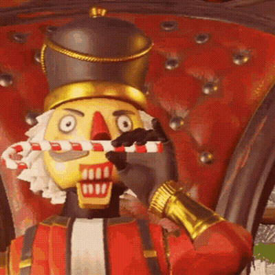 The Nutcracker Is Holding A Candy Cane In His Mouth . GIF