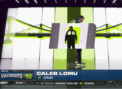 The Patriots Pick Caleb Lomu Is Standing In Front Of A Bridge GIF