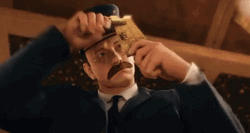 The Polar Express Conductor Punches Holes On Ticket GIF