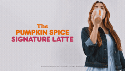The Pumpkin Spice Signature Latte Is Being Poured Into A Clear Cup GIF