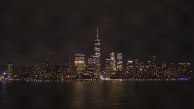 The Skyline Of New York City At Night With One World Trade Center In The Foreground GIF