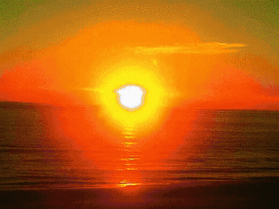The Sun Is Setting Over The Ocean GIF