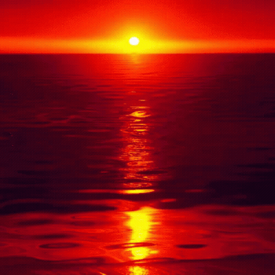 The Sun Is Setting Over The Ocean And The Water Is Red GIF