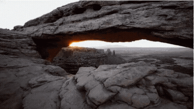 The Sun Is Shining Through A Rock Arch GIF