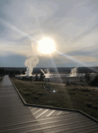 The Sun Is Shining Through The Clouds Over A Geyser Field GIF