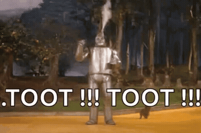 The Tin Man From The Wizard Of Oz Is Blowing Smoke Out Of His Mouth And Says Toot ! GIF