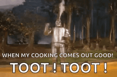 The Tin Man From The Wizard Of Oz Is Standing In The Woods And Smoking A Pipe . GIF