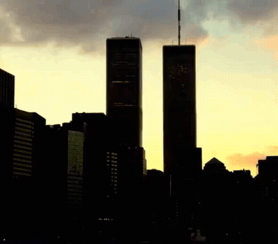 The Twin Towers Are Silhouetted Against A Cloudy Sky At Sunset GIF