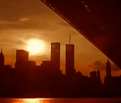 The Twin Towers Are Silhouetted Against A Sunset Skyline GIF
