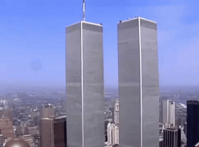 The Twin Towers Of The World Trade Center Are Visible In A Cityscape GIF