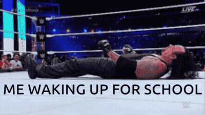 The Undertaker Is Laying On The Ground In A Wrestling Ring GIF