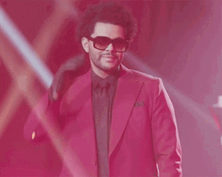 The Weeknd Holds Glasses