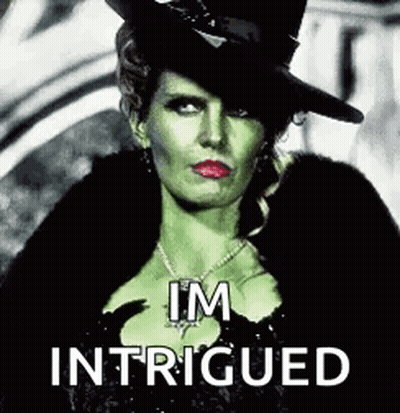 The Wicked Witch From Once Upon A Time Is Wearing A Top Hat And A Fur Coat And Necklace . GIF