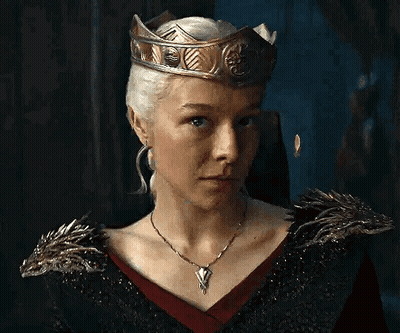 The Woman Is Wearing A Crown And A Necklace . GIF