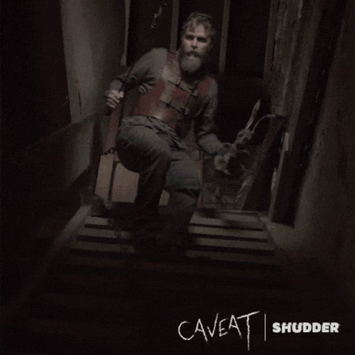 The Word Caveat Is Written On A Wall In A Dark Room GIF