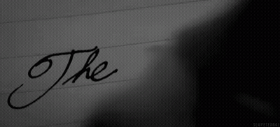 The Word The Is Written In Black Ink On A Piece Of Paper . GIF