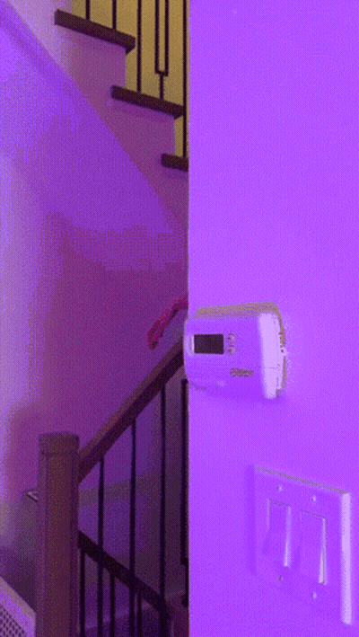 Thermostat On Purple Wall Next To Stairs GIF