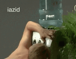Thirsty Naked Man Drinking From Water Dispenser GIF
