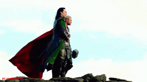 Thor And Loki Are Standing On Top Of A Rocky Hill With A Hammer In Their Hand GIF