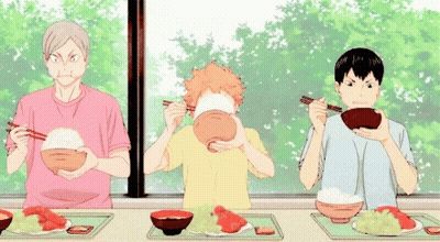 Three Anime Characters Are Sitting At A Table Eating Food . GIF