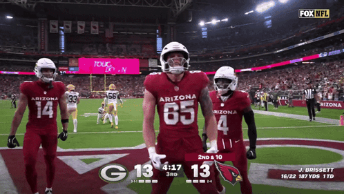 Three Arizona Football Players Celebrate A Touchdown During A Game GIF