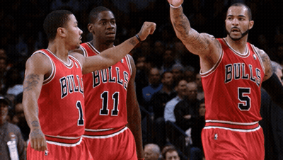 Three Basketball Players Wearing Bulls Uniforms Are Standing Together GIF