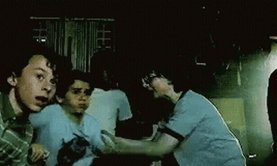 Three Boys Fighting In Dark Room GIF