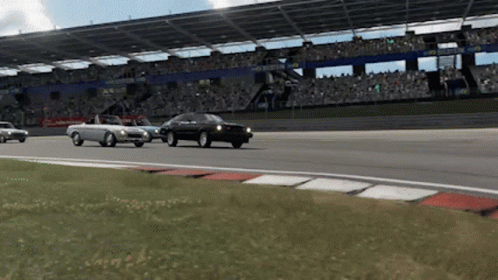 Three Cars Are Driving On A Race Track In Front Of A Crowd And A Sign That Says ' Hyundai ' On It GIF
