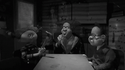 Three Cartoon Characters Are Sitting At A Table In Front Of A Refrigerator That Says ' Hk ' On It GIF