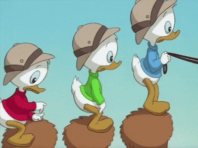 Three Cartoon Ducks In Hats And Sweaters On A Pile GIF