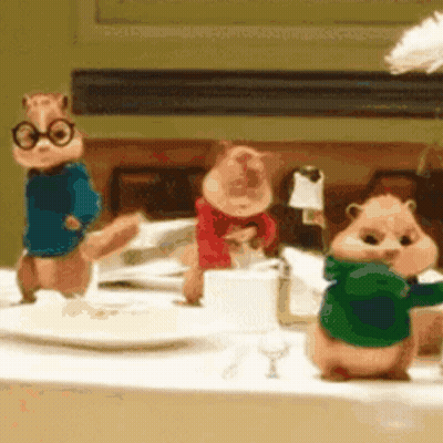 Three Chipmunks Standing On Table GIF