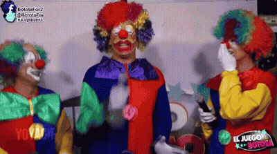 Three Clowns In Front Of El Juego Botola Sign GIF