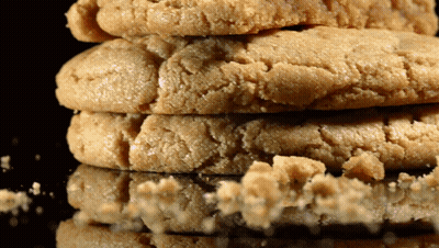 Three Cookies Are Stacked On Top Of Each Other On A Table GIF