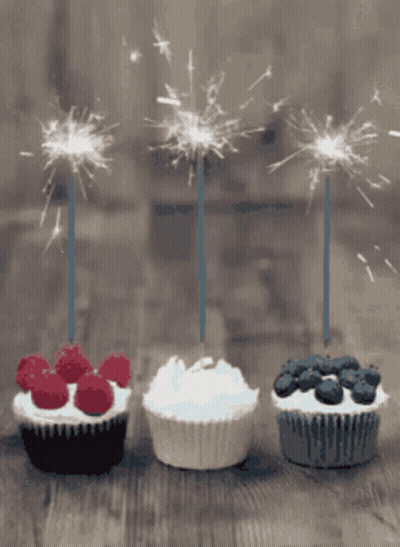 Three Cupcakes With Sparklers Lined Up GIF