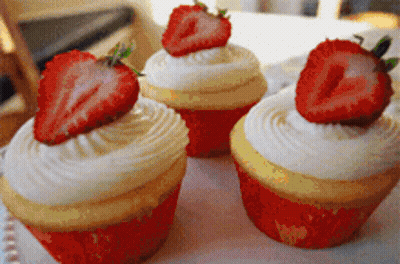 Three Cupcakes With Strawberries On Plate GIF